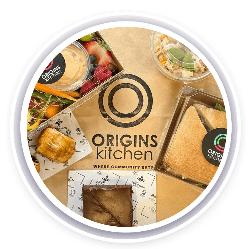 Origins Kitchen logo surrounded by food items