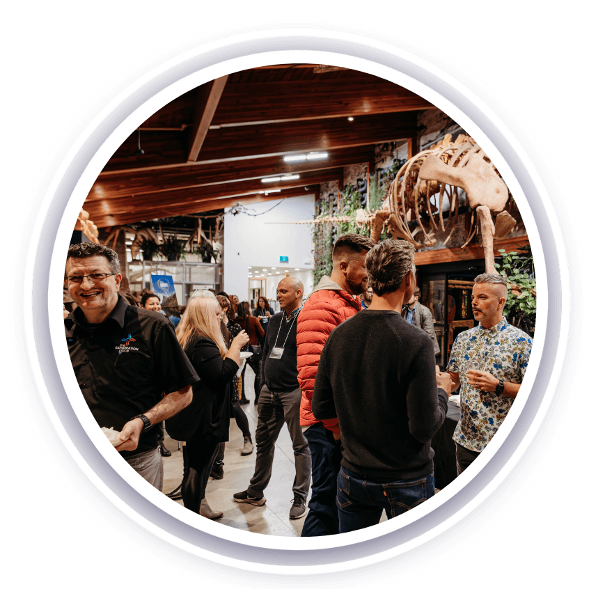 A group of people socializing in a museum gallery
